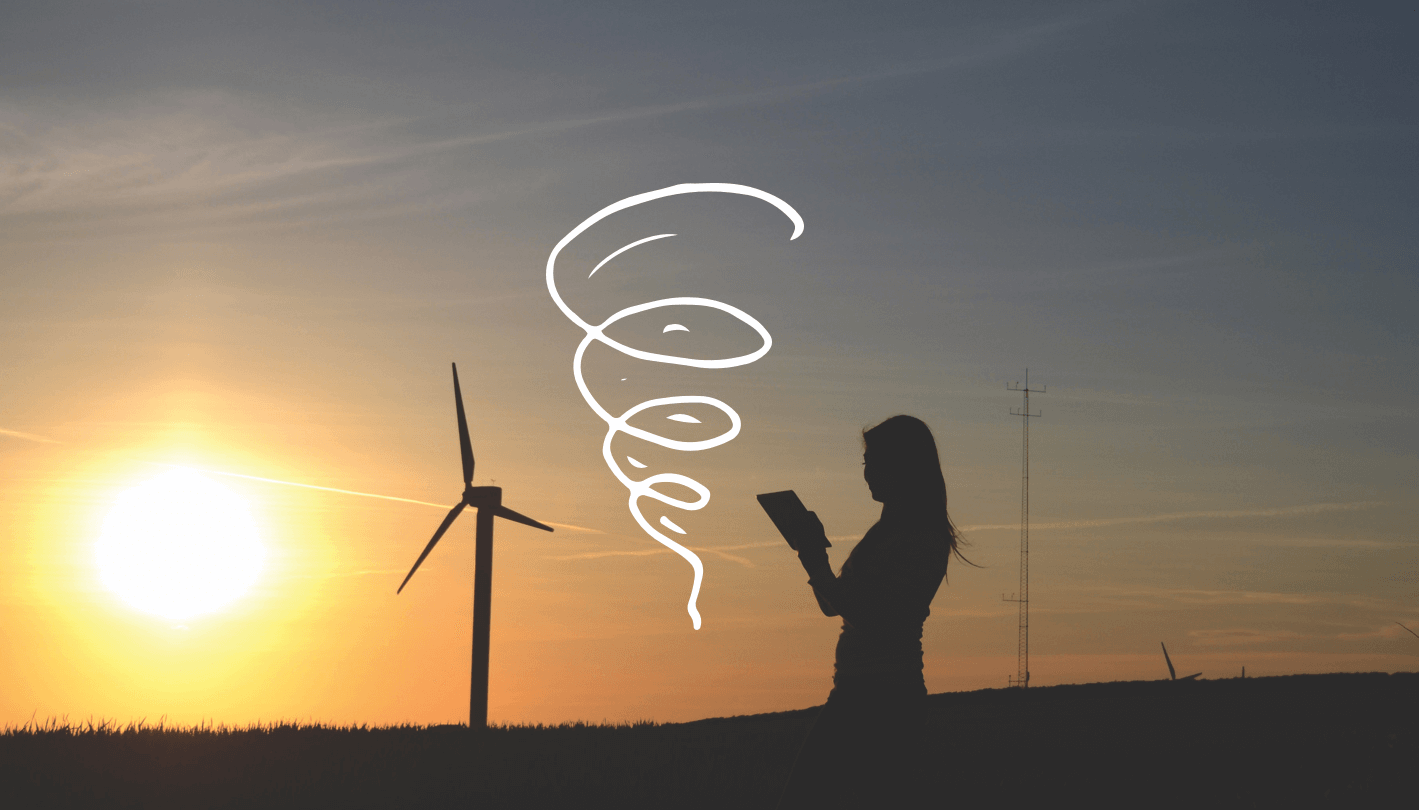 photo of silhouetted woman at sunset with a wind turbine in the background